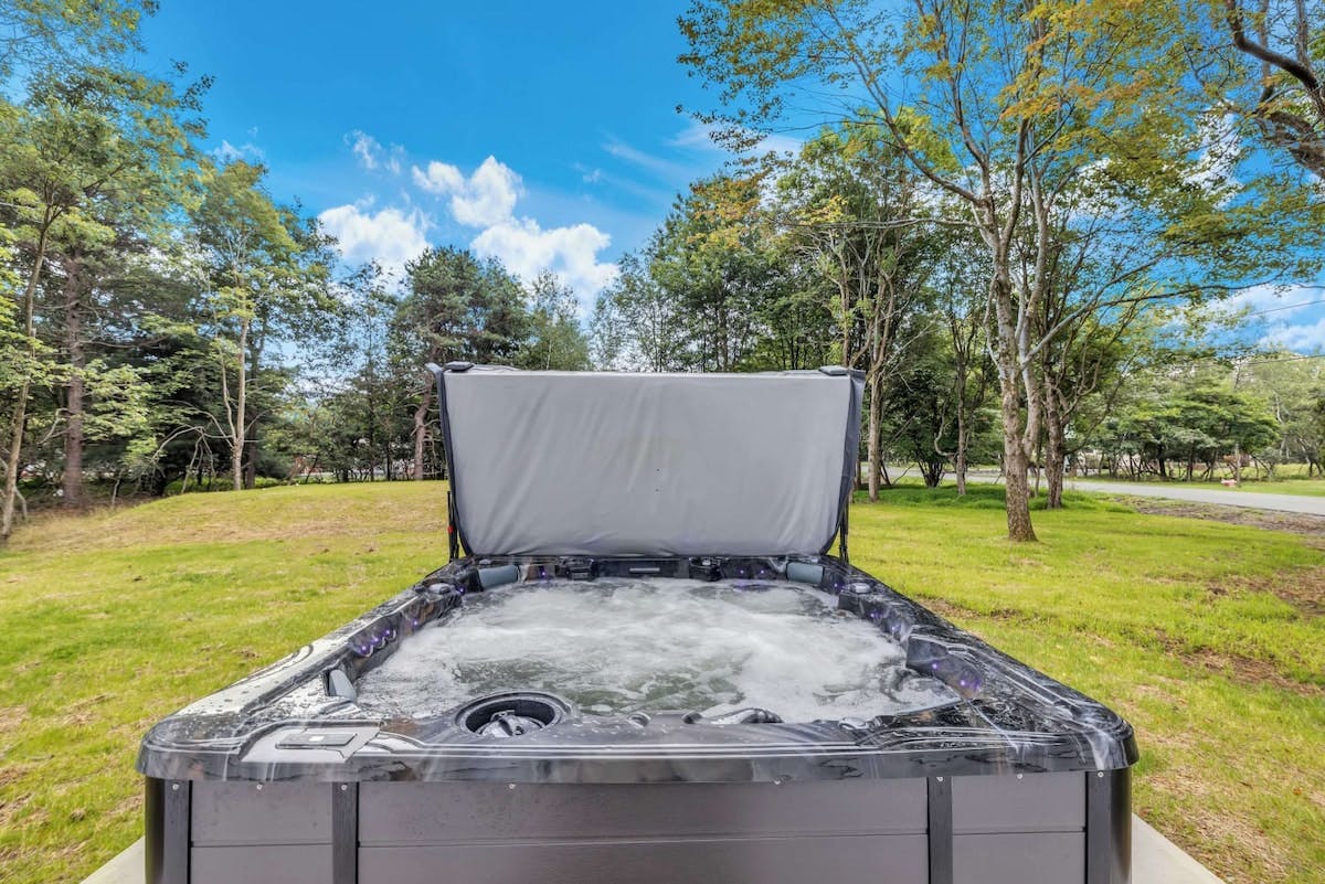 Penn Forest Lodge | Pocono Vacation Rental | Elevate your vacation with a dip in this inviting and revitalizing hot tub for 6 people.}