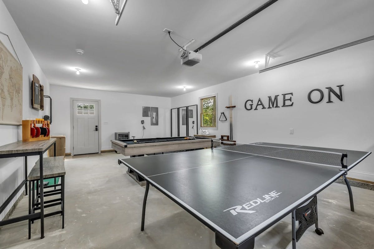 Penn Forest Lodge | Pocono Vacation Rental | Score memorable moments in the game/gym room w/ ping-pong, pool, darts, workout equipment, putting mat, yoga mats & more!}